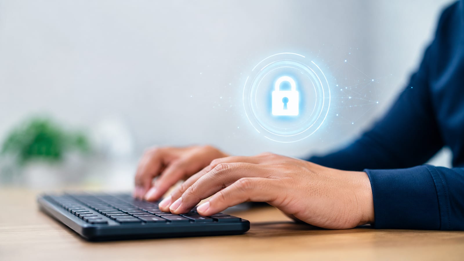 Person typing on keyboard with digital padlock icon symbolizing remote access software security